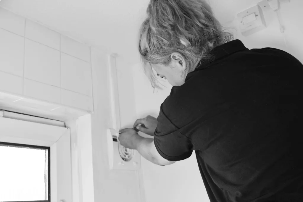 Installer fitting Fan in the Bathroom 
