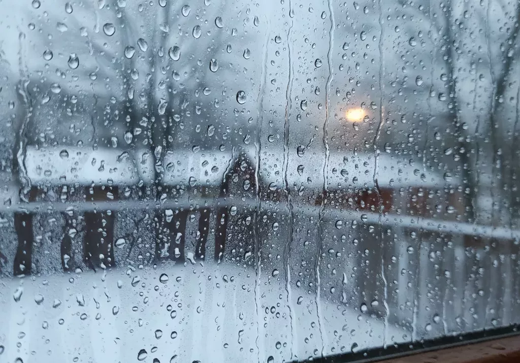 Droplets of condensation running down a window