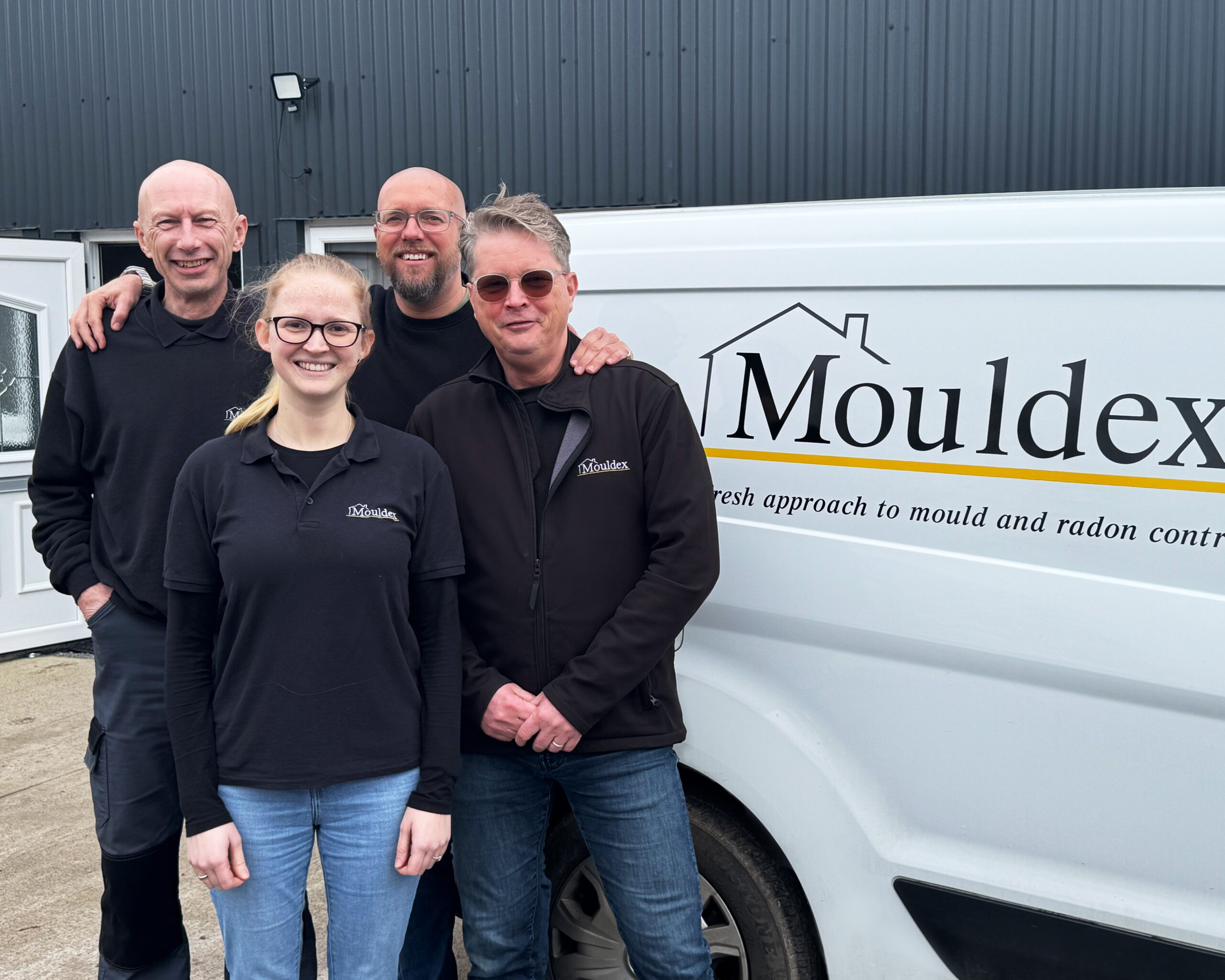 ISO 9001 team members 4 members of the Mouldex team stood next to a Mouldex branded van outside the head office